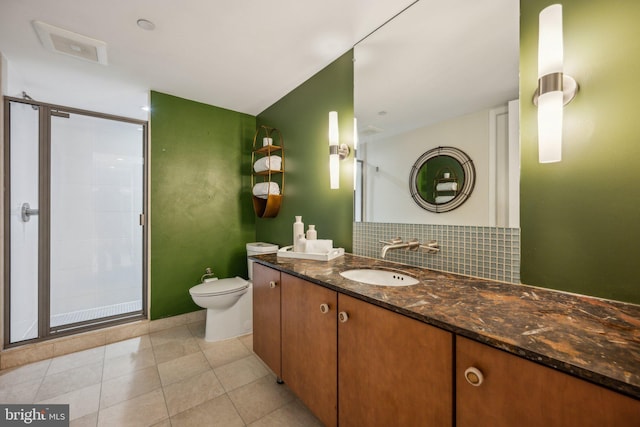 bathroom with walk in shower, toilet, vanity, tile patterned flooring, and backsplash