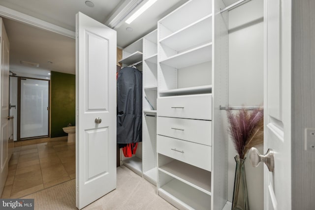 spacious closet featuring light tile patterned floors