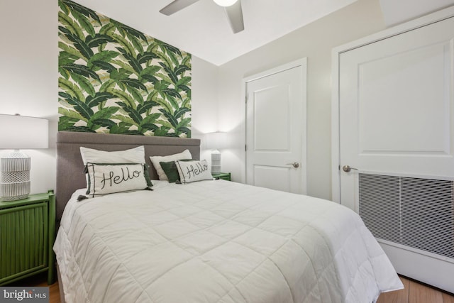 bedroom with radiator heating unit and ceiling fan