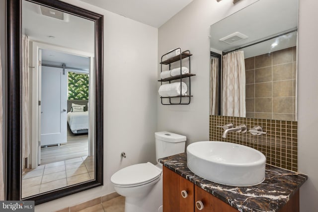 bathroom with toilet, tasteful backsplash, a shower with curtain, vanity, and tile patterned flooring