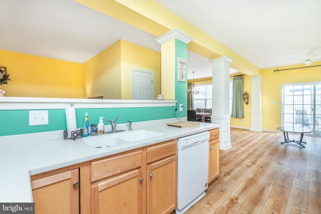 kitchen with sink, ornate columns, an inviting chandelier, light wood-type flooring, and dishwasher