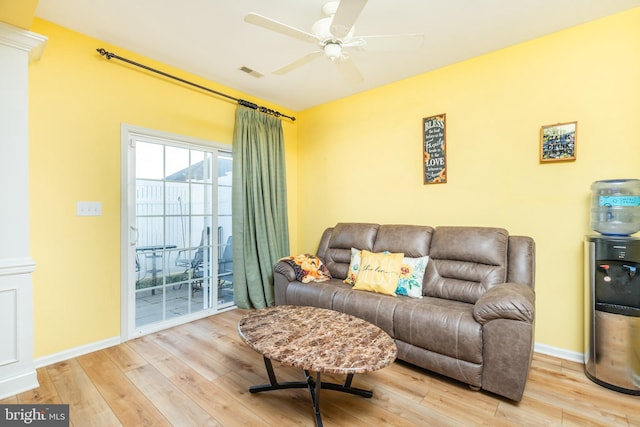 living room with light hardwood / wood-style floors and ceiling fan