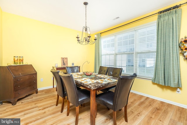 dining space with an inviting chandelier and light wood-type flooring