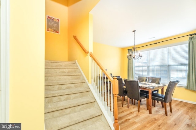 dining space with a chandelier and hardwood / wood-style floors