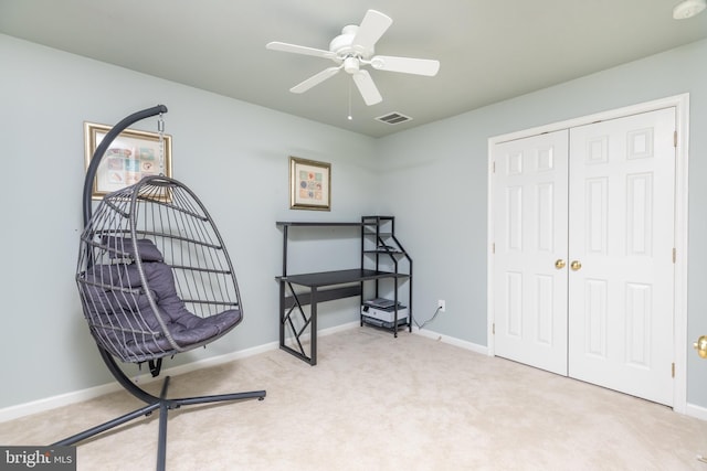 sitting room with light colored carpet and ceiling fan