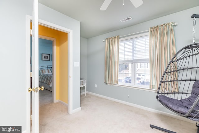 living area featuring ceiling fan and light carpet