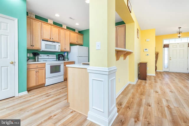 kitchen with light brown cabinets, white appliances, and light hardwood / wood-style flooring