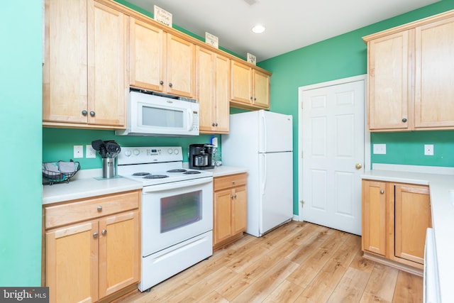 kitchen with white appliances, light hardwood / wood-style flooring, and light brown cabinets