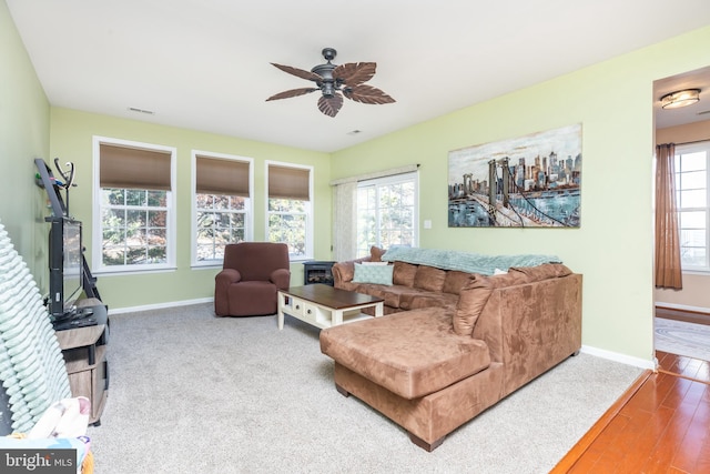 living room featuring hardwood / wood-style flooring and ceiling fan