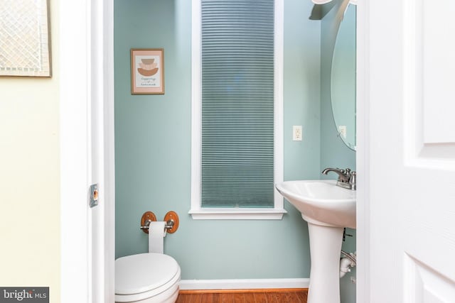 bathroom featuring hardwood / wood-style flooring, toilet, and sink