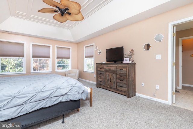 carpeted bedroom featuring ornamental molding, a raised ceiling, and ceiling fan