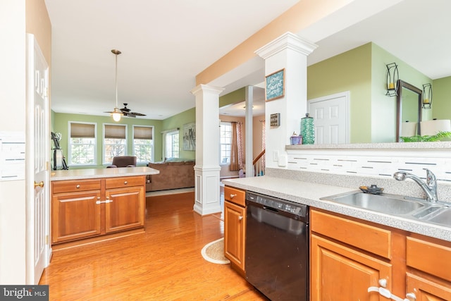 kitchen with sink, ceiling fan, black dishwasher, light hardwood / wood-style floors, and ornate columns