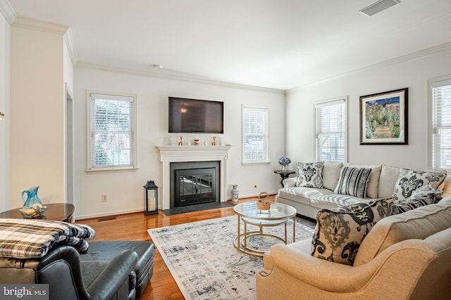 living room with hardwood / wood-style flooring and ornamental molding