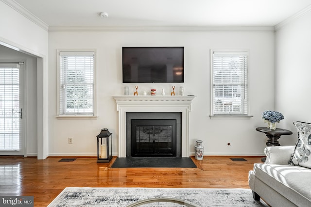 living room featuring hardwood / wood-style flooring and ornamental molding