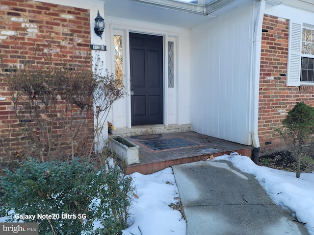 view of snow covered property entrance