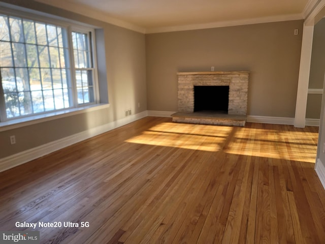 unfurnished living room featuring ornamental molding and light hardwood / wood-style floors