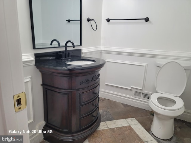 bathroom featuring vanity and toilet