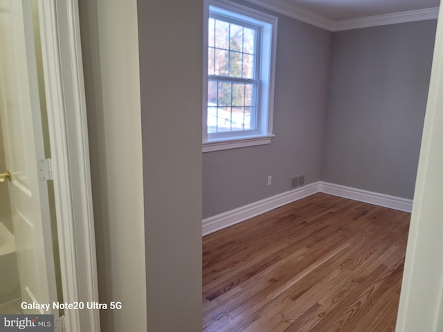 unfurnished room with crown molding and hardwood / wood-style floors