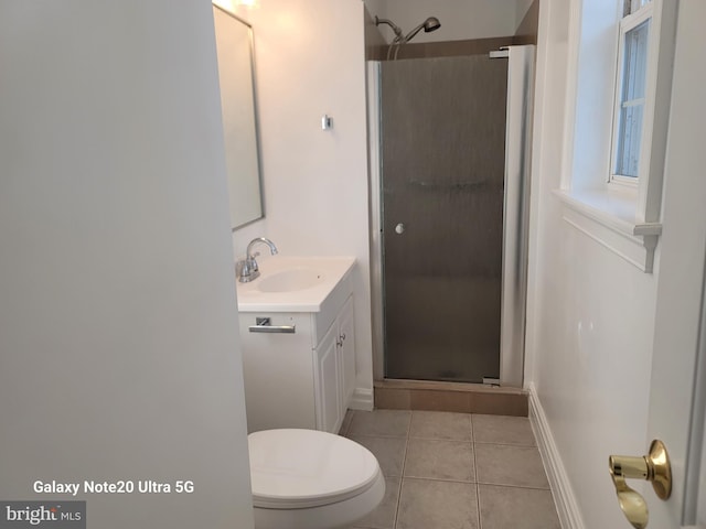 bathroom with an enclosed shower, vanity, tile patterned flooring, and toilet