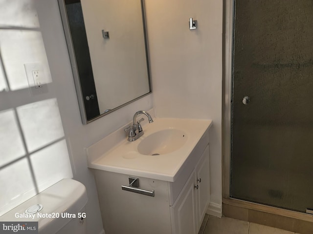 bathroom featuring vanity, an enclosed shower, tile patterned floors, and toilet