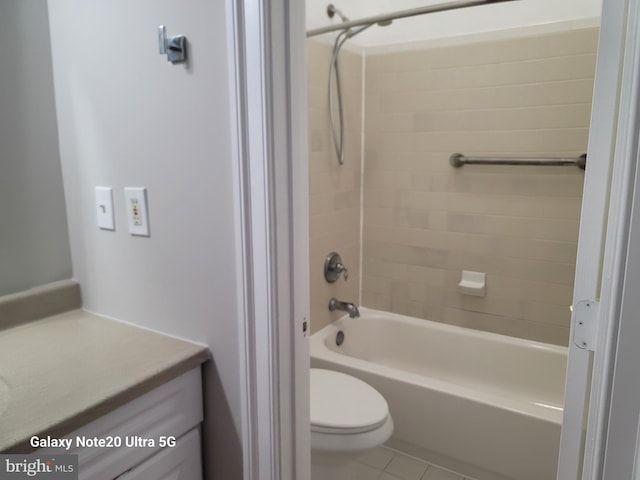 full bathroom with tiled shower / bath, vanity, toilet, and tile patterned floors