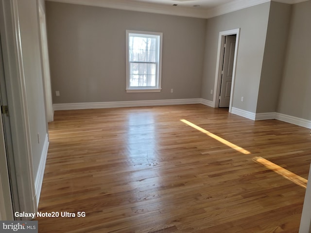 unfurnished room featuring crown molding and hardwood / wood-style floors