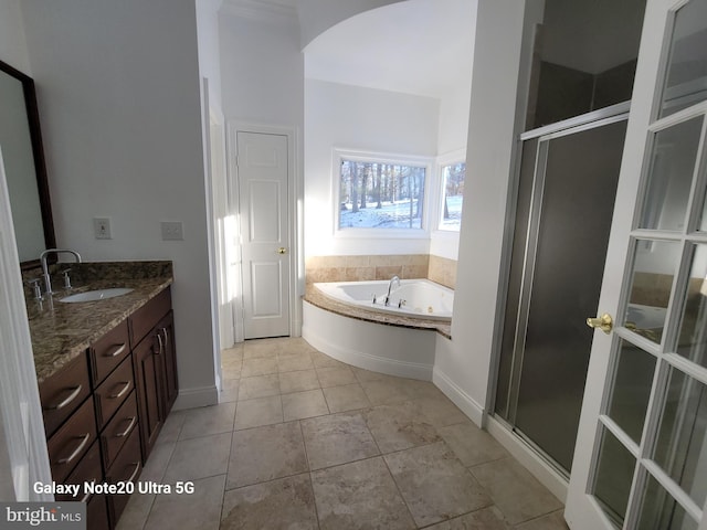 bathroom with tile patterned flooring, vanity, and shower with separate bathtub