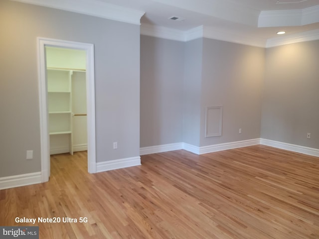 unfurnished room featuring crown molding and light hardwood / wood-style flooring