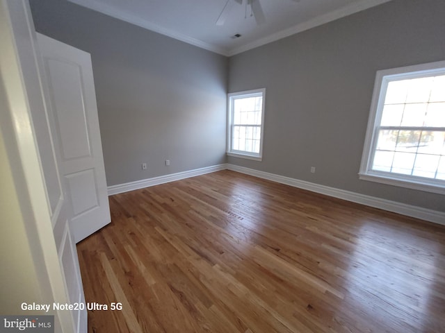 unfurnished room featuring wood-type flooring, ornamental molding, and ceiling fan