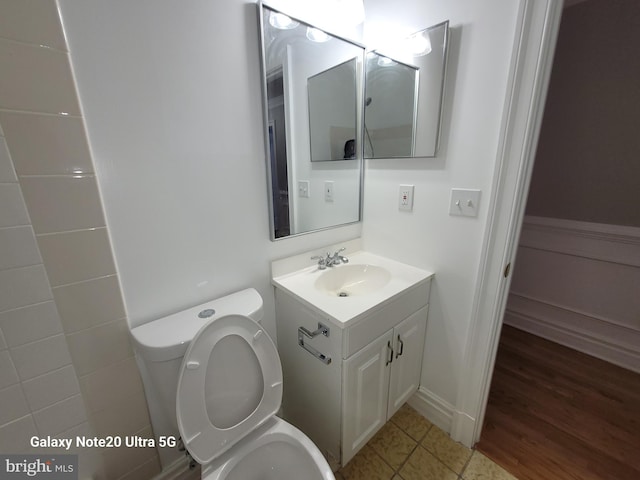 bathroom featuring vanity, toilet, and tile patterned flooring