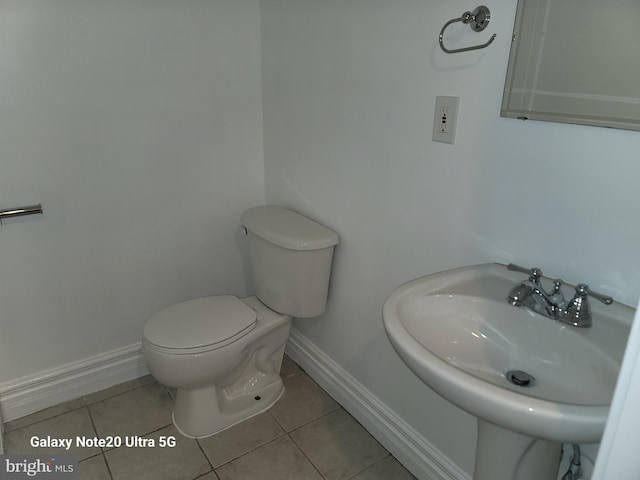 bathroom with sink, tile patterned floors, and toilet