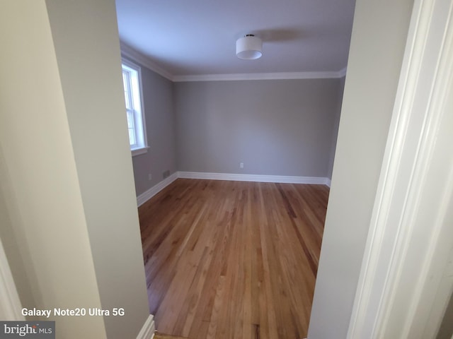 unfurnished room featuring crown molding and light hardwood / wood-style flooring