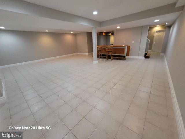 basement with light tile patterned flooring