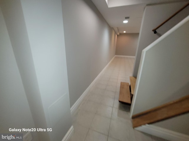 hall featuring light tile patterned flooring