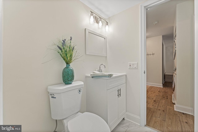 bathroom with vanity, toilet, and hardwood / wood-style floors