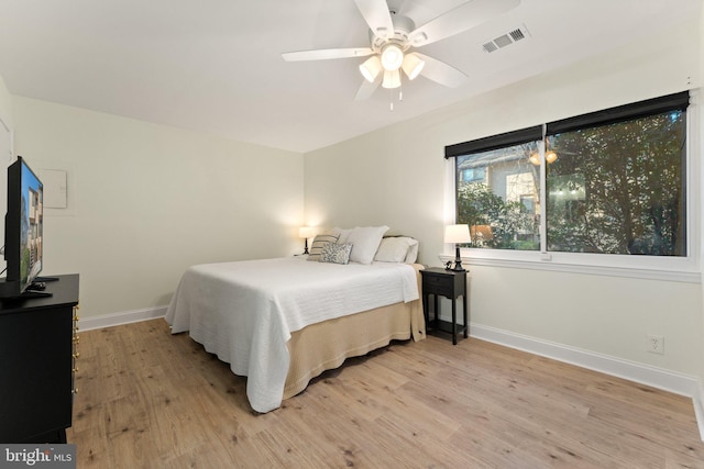 bedroom with light hardwood / wood-style floors and ceiling fan