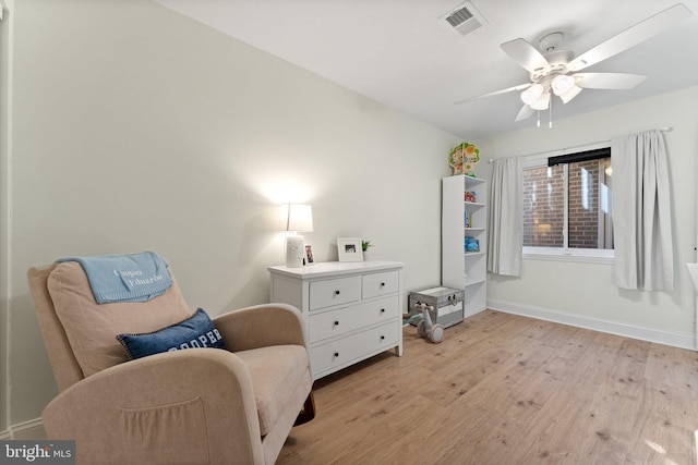 living area featuring ceiling fan and light hardwood / wood-style floors