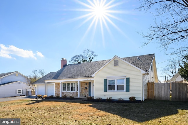 view of front of property with a garage and a front yard