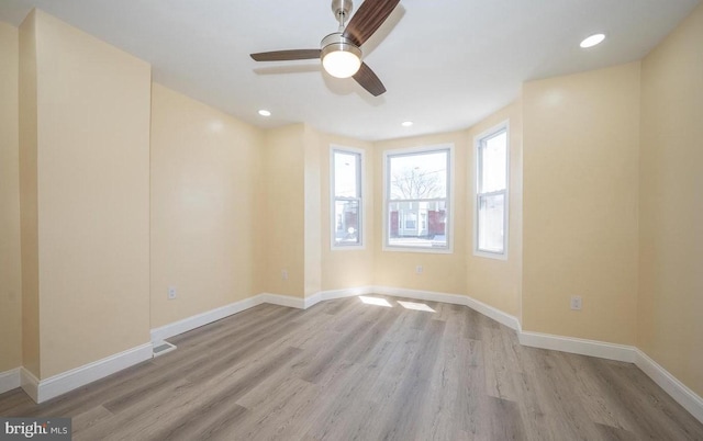 spare room featuring light hardwood / wood-style flooring and ceiling fan