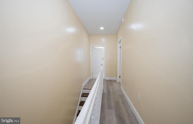 corridor with light hardwood / wood-style floors