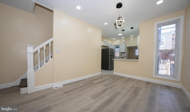 unfurnished living room featuring light hardwood / wood-style flooring