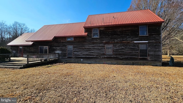 view of front of property with metal roof and a wooden deck