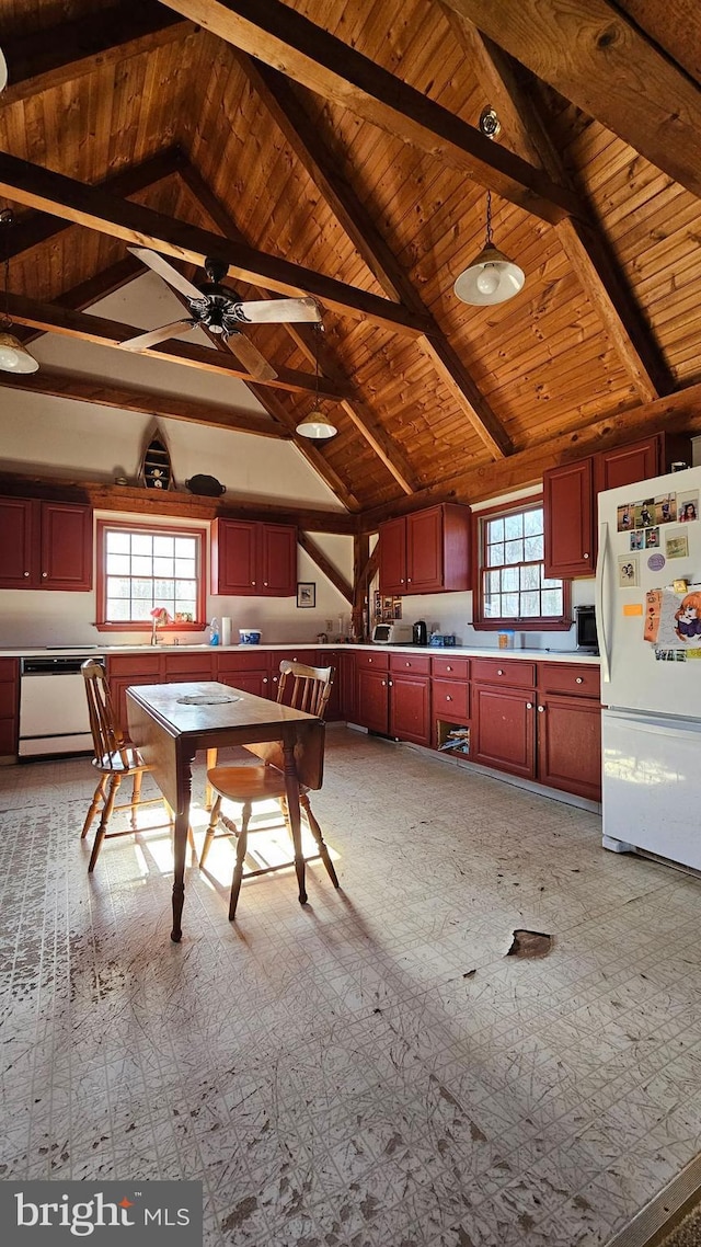 kitchen featuring reddish brown cabinets, vaulted ceiling with beams, light countertops, wooden ceiling, and white appliances