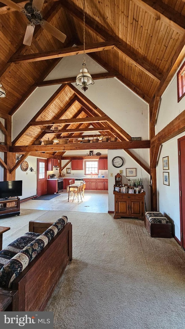 interior space with carpet, beam ceiling, a ceiling fan, wood ceiling, and high vaulted ceiling