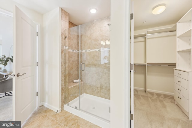 bathroom with a shower with door