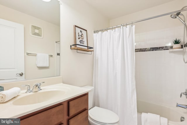 full bathroom featuring vanity, toilet, and shower / bathtub combination with curtain