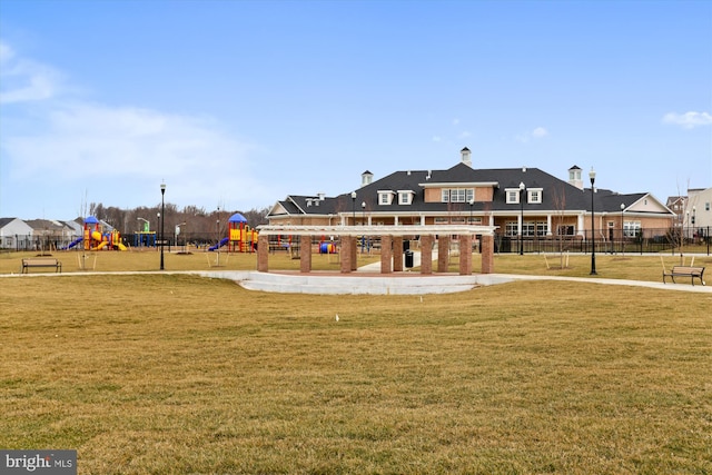 view of community with a lawn and a playground