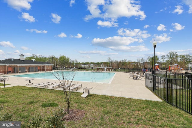 view of pool featuring a yard and a patio area