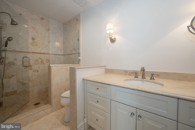 bathroom with tile patterned flooring, vanity, an enclosed shower, and toilet