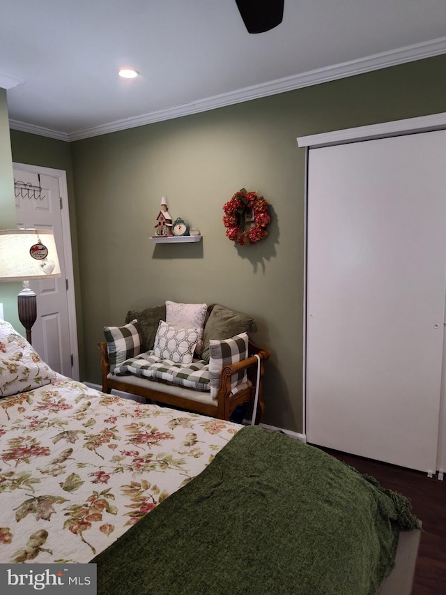 bedroom with dark wood finished floors, recessed lighting, a closet, and crown molding